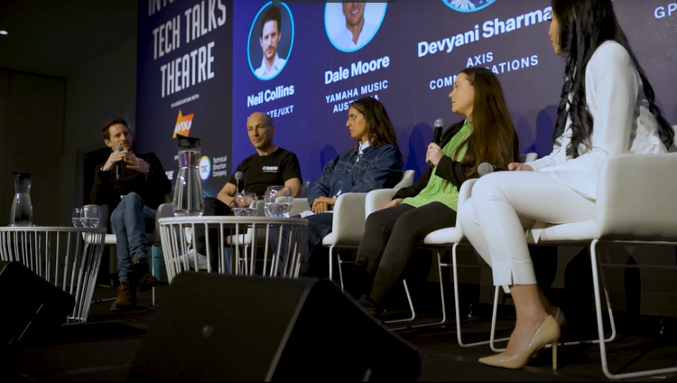Keynotes & lecturing - Dreamforce · SXSW · UNSW · Integrate/AVIXA Neil Collins, fractional CMO Australia, hosting a keynote panel on stage at a global marketing and technology conference.